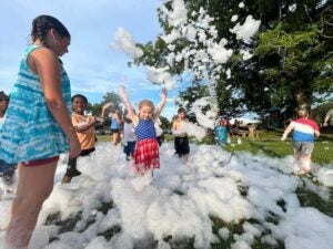 Children enjoyed playing in the foam prior to the fireworks show.