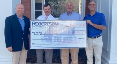 W. Gary Holemon, President & CEO of Robertson Banking Company, left, and Pete Reynolds, CFO of Robertson Banking Company, right, present Rob Pearson and Kirk Stephens of the ASHS Foundation, with a $30,000 check to support the school. | Submitted Photo