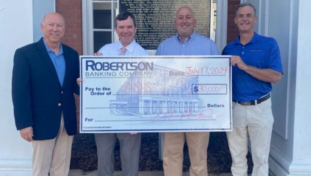 W. Gary Holemon, President & CEO of Robertson Banking Company, left, and Pete Reynolds, CFO of Robertson Banking Company, right, present Rob Pearson and Kirk Stephens of the ASHS Foundation, with a $30,000 check to support the school. | Submitted Photo