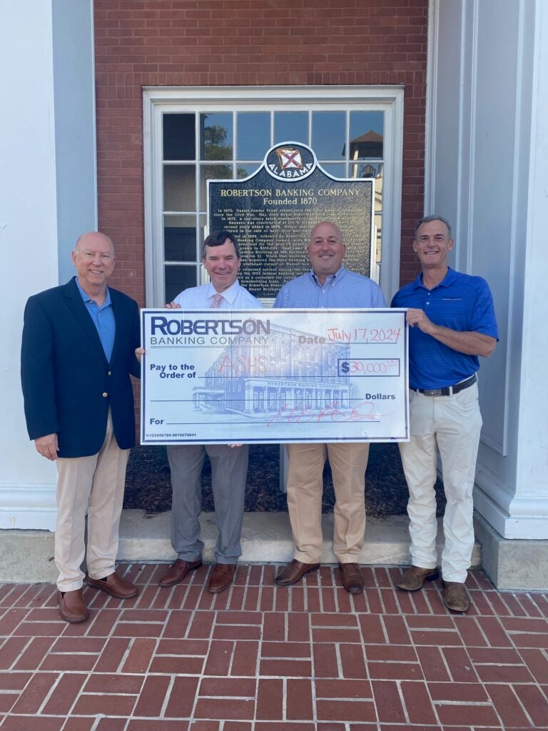 W. Gary Holemon, President & CEO of Robertson Banking Company, left, and Pete Reynolds, CFO of Robertson Banking Company, right, present Rob Pearson and Kirk Stephens of the ASHS Foundation, with a $30,000 check to support the school. | Submitted Photo